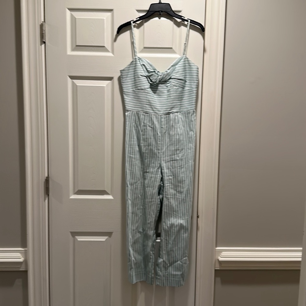 Mint green striped jumpsuit with spaghetti straps. Size 4. New with tags.